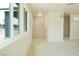 Hallway with light walls and flooring that leads to the front door and living spaces at 220 N David St, Pahrump, NV 89060