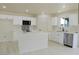 Bright kitchen with stainless steel appliances, white cabinets, an island, and modern countertops at 220 N David St, Pahrump, NV 89060