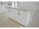 Kitchen island featuring quartz countertops and sleek white cabinetry at 220 N David St, Pahrump, NV 89060