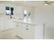 Open-concept kitchen featuring stainless steel appliances, white cabinets, and a central island at 220 N David St, Pahrump, NV 89060