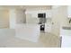 Bright kitchen featuring white cabinets, island, stainless steel appliances and sleek backsplash at 220 N David St, Pahrump, NV 89060