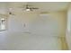 Spacious living room with light walls, light floors and multiple ceiling fans at 220 N David St, Pahrump, NV 89060