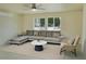 Living room virtually staged with neutral couch and chair with bright natural light at 220 N David St, Pahrump, NV 89060