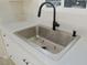 Stainless steel sink and faucet with white countertops create a clean kitchen space at 220 N David St, Pahrump, NV 89060