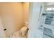 Toilet room with marble-look tile and access to a step-in shower at 220 N David St, Pahrump, NV 89060
