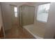 Bright bathroom with a separate shower and soaking tub, complemented by natural light from the window at 2520 Living Rock St, Las Vegas, NV 89106