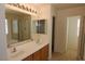 Bathroom featuring double sinks, a shower, and tile floors, designed for comfort and functionality at 2520 Living Rock St, Las Vegas, NV 89106