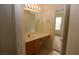 Bright bathroom featuring a single sink, vanity, large mirror, and neutral tile floors at 2520 Living Rock St, Las Vegas, NV 89106