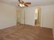 Carpeted bedroom offering ample space, a ceiling fan, and an ensuite bathroom, perfect for relaxation and privacy at 2520 Living Rock St, Las Vegas, NV 89106