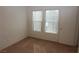 Cozy carpeted bedroom with two windows and neutral paint at 2520 Living Rock St, Las Vegas, NV 89106