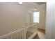 Well-lit hallway with carpeted floors and a staircase, providing seamless transition between levels of the home at 2520 Living Rock St, Las Vegas, NV 89106