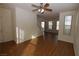 Open-concept living area with hardwood floors, ceiling fan and staircase at 2520 Living Rock St, Las Vegas, NV 89106