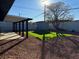 An expansive backyard featuring turf, gravel, a shed, and covered patio at 2820 Richfield Blvd, Las Vegas, NV 89102