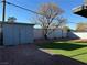An expansive backyard featuring gravel, turf, a shed, and a brick wall at 2820 Richfield Blvd, Las Vegas, NV 89102