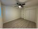 The bedroom features wood-look floors, a ceiling fan, closet and a door at 2820 Richfield Blvd, Las Vegas, NV 89102