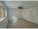 Bright bedroom featuring wood-look flooring, and a ceiling fan and large window at 2820 Richfield Blvd, Las Vegas, NV 89102