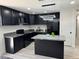 Well-appointed kitchen with sleek black cabinets, modern lighting, and a functional island at 2820 Richfield Blvd, Las Vegas, NV 89102