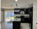 Modern kitchen featuring dark cabinetry, an island with countertop, and stainless steel appliances at 2820 Richfield Blvd, Las Vegas, NV 89102