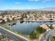 Neighborhood aerial view of lush landscaping and beautiful waterfront homes surrounding a private lake at 2908 Reef Bay Ln, Las Vegas, NV 89128