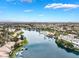 Beautiful community aerial view featuring lakefront homes, landscaping, and stunning blue skies at 2908 Reef Bay Ln, Las Vegas, NV 89128