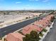 Community aerial view of tile-roofed townhomes with city and mountain views in the background at 2908 Reef Bay Ln, Las Vegas, NV 89128