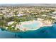 Lake community aerial view showing beach lagoon with white sand and surrounding lush tropical landscaping at 2908 Reef Bay Ln, Las Vegas, NV 89128