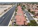 Beautiful aerial view showcasing community homes with tidy landscaping, mature trees, and nearby roadways at 2908 Reef Bay Ln, Las Vegas, NV 89128