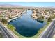 Gorgeous lake community view showing lush landscaping, waterfront properties and a mountain backdrop at 2908 Reef Bay Ln, Las Vegas, NV 89128