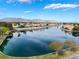 A serene community view showcasing a calm lake surrounded by homes and mountains in the background at 2908 Reef Bay Ln, Las Vegas, NV 89128