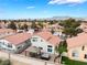 Beautiful community view featuring tiled roofs, mature trees, and a serene mountain backdrop at 2908 Reef Bay Ln, Las Vegas, NV 89128