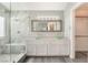 Modern bathroom featuring a double sink vanity, shower and closet at 2908 Reef Bay Ln, Las Vegas, NV 89128