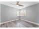 This bedroom features new gray flooring, cool gray walls, and a modern ceiling fan at 2908 Reef Bay Ln, Las Vegas, NV 89128