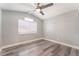This bedroom features gray floors, neutral walls, and a modern ceiling fan at 2908 Reef Bay Ln, Las Vegas, NV 89128