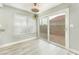 Bright dining area with hardwood floors, a ceiling fan, and sliding glass doors leading to the backyard at 2908 Reef Bay Ln, Las Vegas, NV 89128