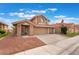 Inviting two-story home with a spacious three-car garage and a well-manicured front yard at 2908 Reef Bay Ln, Las Vegas, NV 89128
