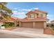 Charming two-story home with a three-car garage, red tile roof, and well-maintained landscaping at 2908 Reef Bay Ln, Las Vegas, NV 89128
