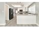Modern kitchen features new appliances, white cabinets, and gorgeous marble countertops and backsplash at 2908 Reef Bay Ln, Las Vegas, NV 89128