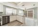 Bright kitchen boasts stainless steel appliances, marble countertops, and a view to the backyard at 2908 Reef Bay Ln, Las Vegas, NV 89128