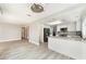 Modern kitchen with stainless steel appliances, white cabinets, marble countertops, and hardwood flooring at 2908 Reef Bay Ln, Las Vegas, NV 89128