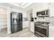The kitchen features stainless steel appliances, modern cabinets, and ample storage space at 2908 Reef Bay Ln, Las Vegas, NV 89128