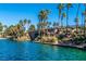 Picturesque view of stone bridge over a turquoise lake, creating a peaceful and scenic community amenity at 2908 Reef Bay Ln, Las Vegas, NV 89128