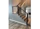 Elegant staircase with wood steps and modern railings leads to a bright living space featuring a fireplace at 2908 Reef Bay Ln, Las Vegas, NV 89128