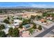 Wide aerial shot showcasing a home with a pool, solar panels, and mature trees in a residential area at 3015 Duneville St, Las Vegas, NV 89146