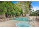Beautiful pool and spa area, surrounded by lush landscaping and a stone border creating a private retreat at 3015 Duneville St, Las Vegas, NV 89146