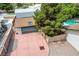 Aerial view of a backyard featuring a garage, mature tree, and concrete driveway with a basketball hoop at 3015 Duneville St, Las Vegas, NV 89146