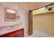 Simple bathroom with vanity and storage, plus access to a closet at 3015 Duneville St, Las Vegas, NV 89146