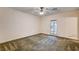 Spacious bedroom features plush carpet, ceiling fan, and direct outdoor access at 3015 Duneville St, Las Vegas, NV 89146