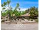 Charming single story home featuring a lush front yard with mature trees and shrubs at 3015 Duneville St, Las Vegas, NV 89146