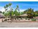 Charming single-story home featuring a well-manicured front yard with mature trees and desert landscaping at 3015 Duneville St, Las Vegas, NV 89146