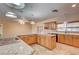 Spacious kitchen with a granite countertop island, wooden cabinets, and modern appliances at 3015 Duneville St, Las Vegas, NV 89146
